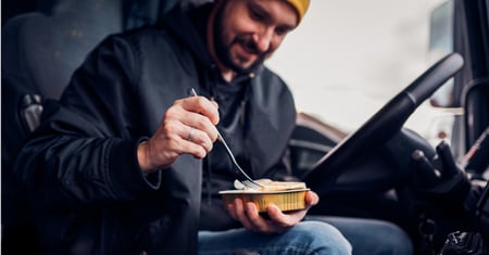truck driver eating in cab
